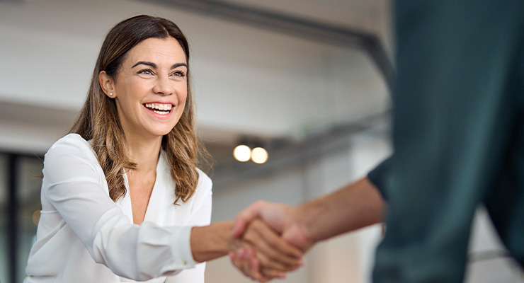 woman smiling and shaking hands with man